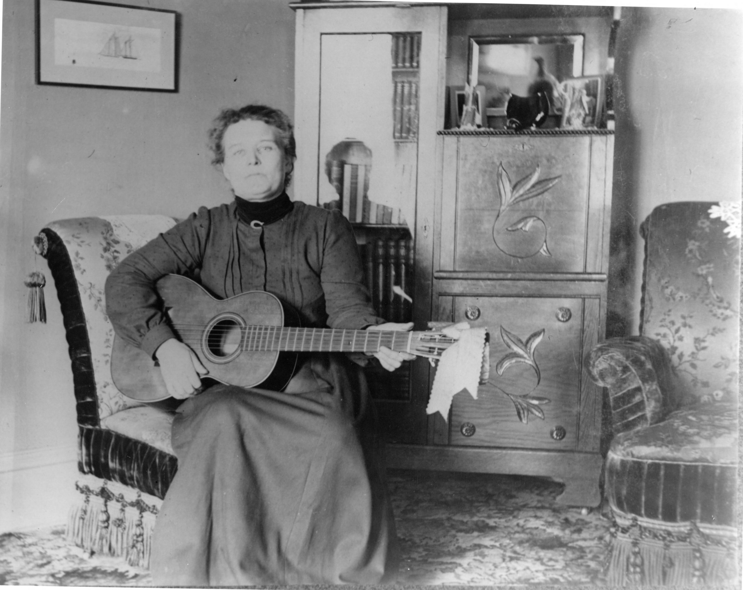 Many Utah homes contained musical instruments. Here a woman poses with her guitar around the turn of the 20th century.
